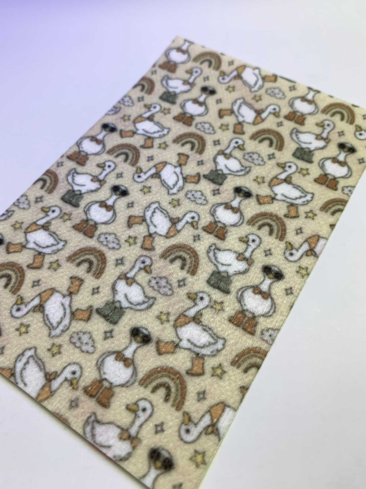 4x6" tubie tape featuring a neutral beige background with white geese wearing brown boots in a repeating pattern. Includes rainbows, clouds, and small stars in earthy tones. Warm, playful, and rustic-inspired design.