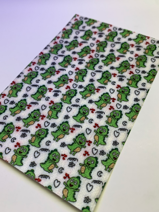 4x6" tubie tape featuring a white background with small green cartoon dinosaurs in a repeating pattern. Includes hearts, stars, and playful doodle accents in black and red. Fun, whimsical, and kid-friendly design.

