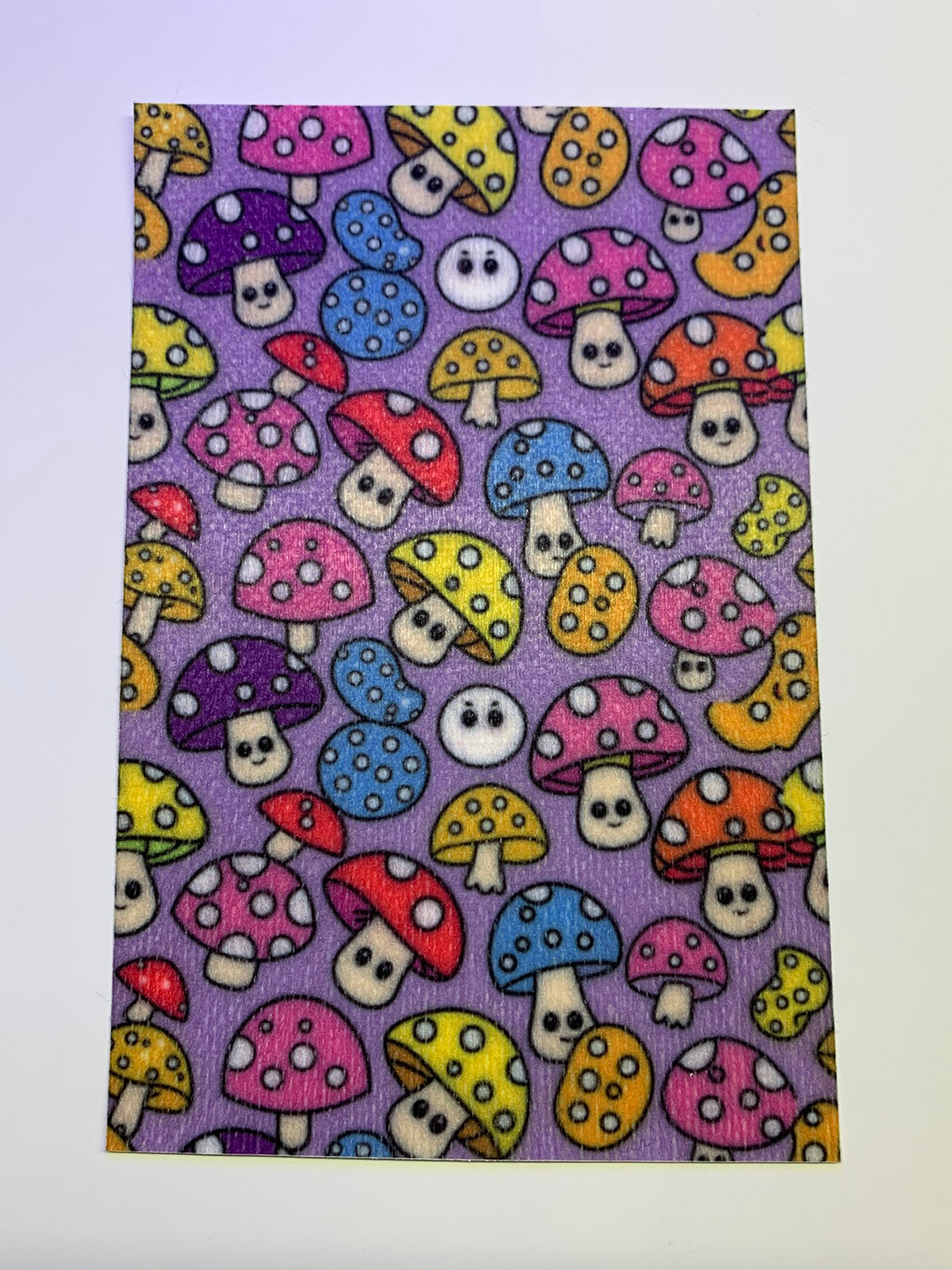 4x6" tubie tape featuring a purple background with colorful mushrooms in a repeating pattern. Mushrooms include pink, blue, yellow, red, and orange caps with white spots and cute faces. Bright, playful, and whimsical design.
