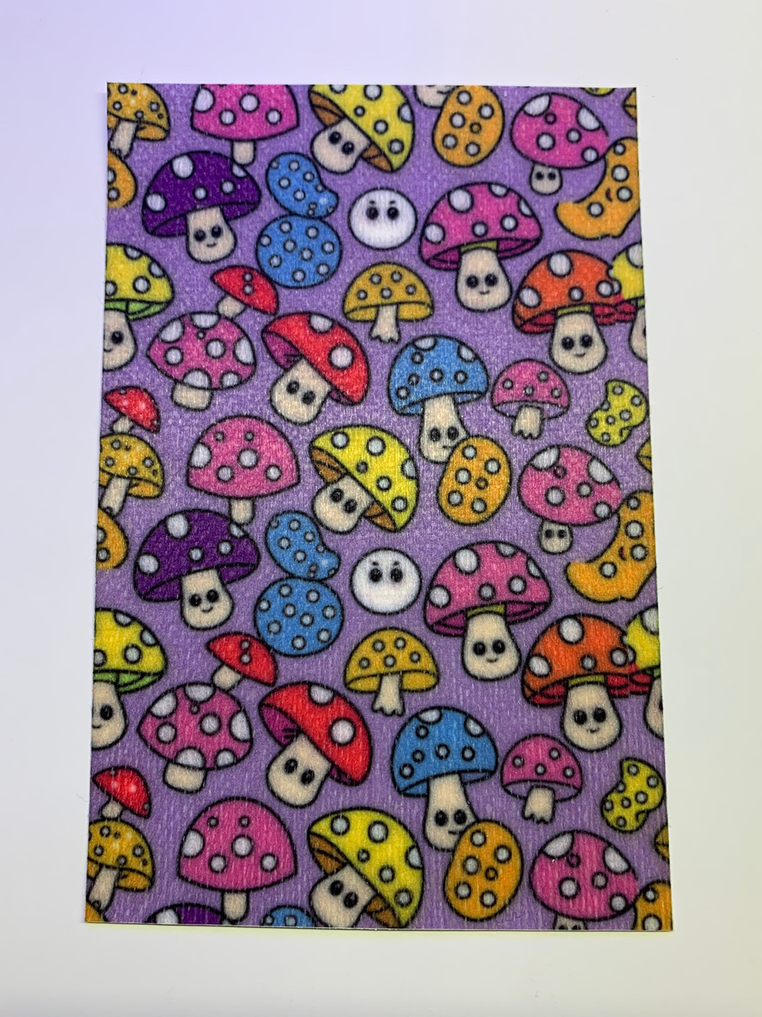 4x6" tubie tape featuring a purple background with colorful mushrooms in a repeating pattern. Mushrooms include pink, blue, yellow, red, and orange caps with white spots and cute faces. Bright, playful, and whimsical design.
