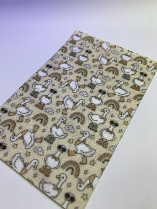 4x6" tubie tape featuring a neutral beige background with white geese wearing brown boots in a repeating pattern. Includes rainbows, clouds, and small stars in earthy tones. Warm, playful, and rustic-inspired design.
