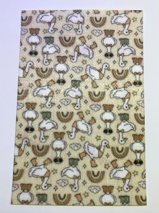 4x6" tubie tape featuring a neutral beige background with white geese wearing brown boots in a repeating pattern. Includes rainbows, clouds, and small stars in earthy tones. Warm, playful, and rustic-inspired design.
