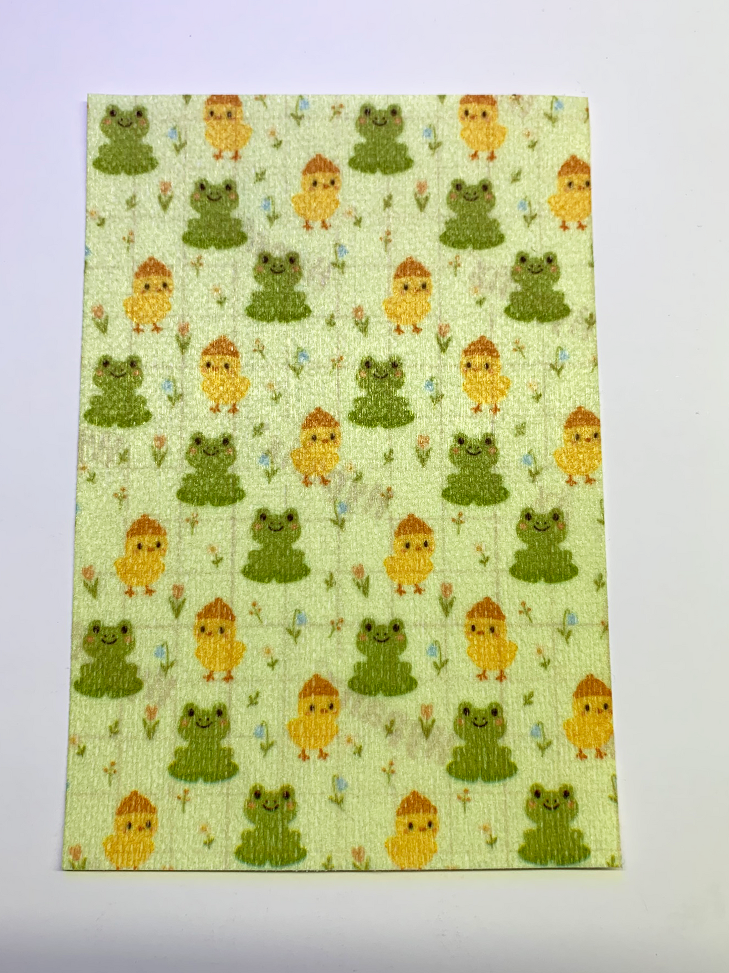 4x6" tubie tape featuring a soft green background with alternating cute frogs and yellow chicks in a repeating pattern. Includes small flowers and nature details throughout. Playful, spring-inspired, and whimsical design.
