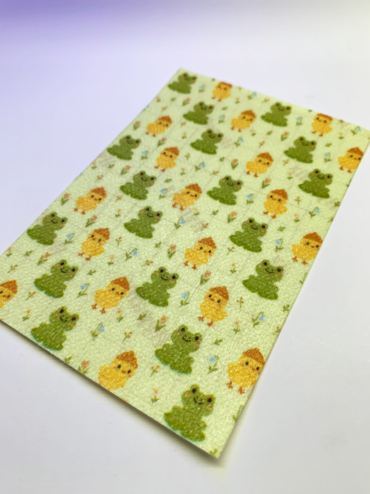 4x6" tubie tape featuring a soft green background with alternating cute frogs and yellow chicks in a repeating pattern. Includes small flowers and nature details throughout. Playful, spring-inspired, and whimsical design.
