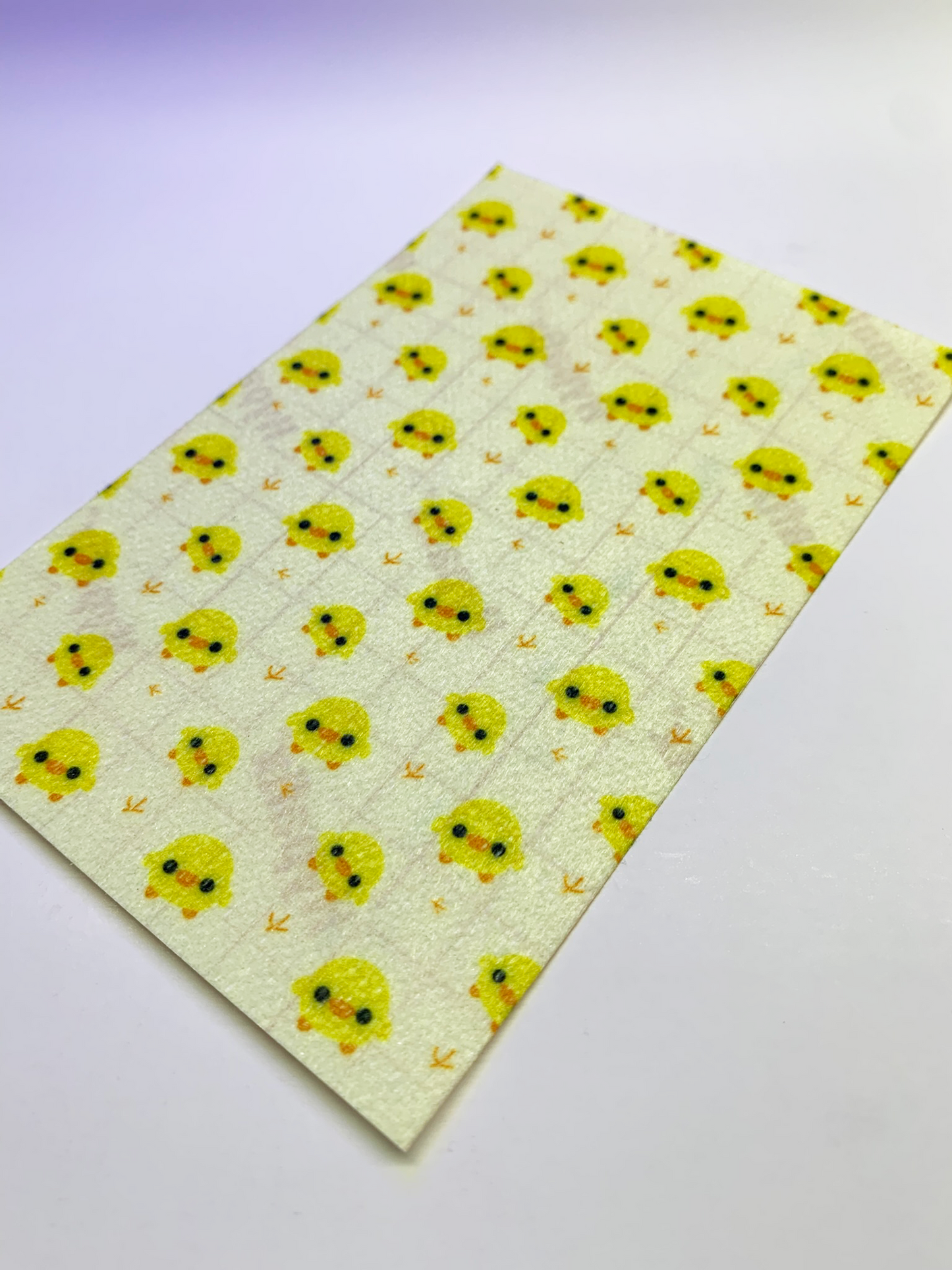 4x6" tubie tape featuring a soft pastel yellow background with small kawaii-style yellow chicks in a repeating pattern. Each chick has simple black eyes and orange beaks, with tiny footprints between them. Cute, minimal, and baby-inspired design.