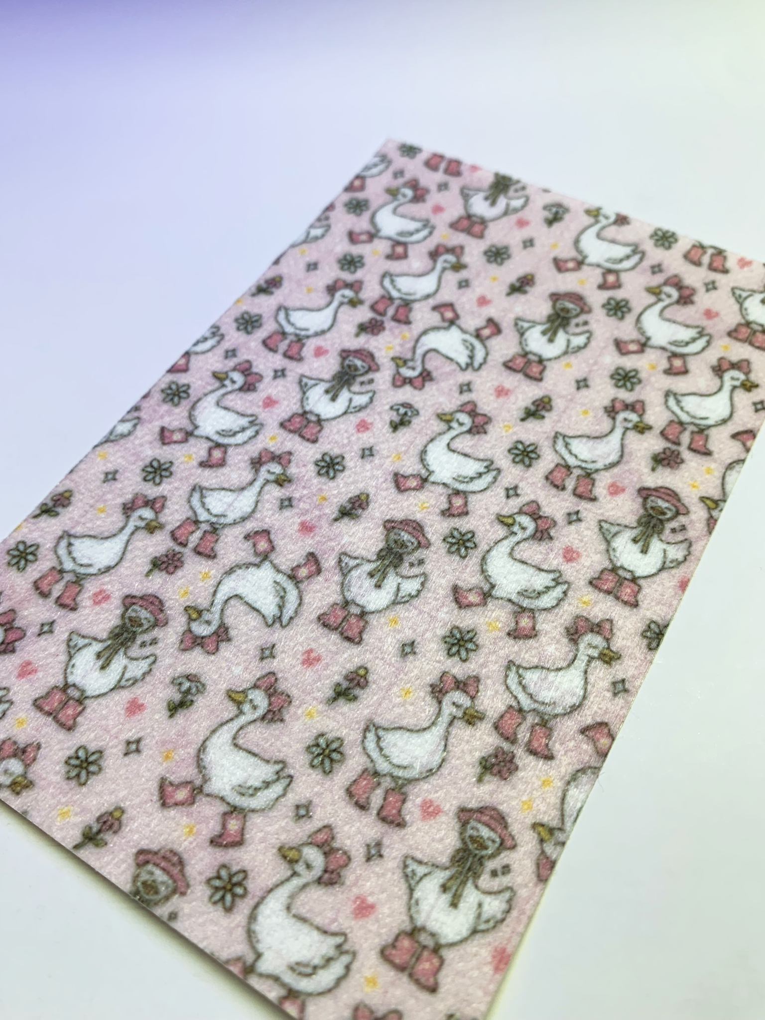 4x6" tubie tape featuring a light pink background with white geese wearing pink boots, bows, and bonnets in a repeating pattern. Includes small flowers and hearts in soft pastel tones. Playful, feminine, and nursery-inspired design.