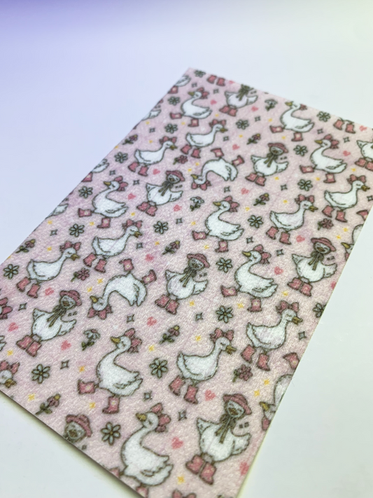 4x6" tubie tape featuring a light pink background with white geese wearing pink boots, bows, and bonnets in a repeating pattern. Includes small flowers and hearts in soft pastel tones. Playful, feminine, and nursery-inspired design.