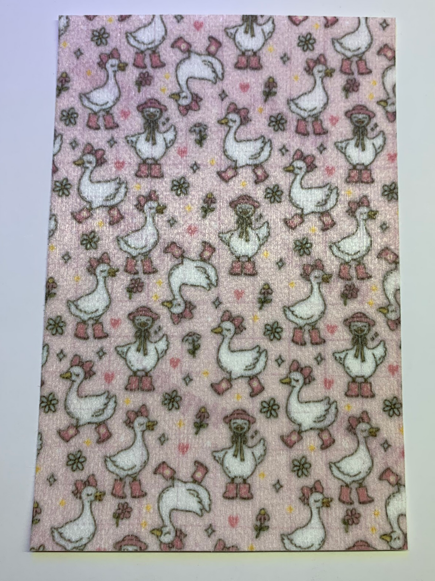 4x6" tubie tape featuring a light pink background with white geese wearing pink boots, bows, and bonnets in a repeating pattern. Includes small flowers and hearts in soft pastel tones. Playful, feminine, and nursery-inspired design.