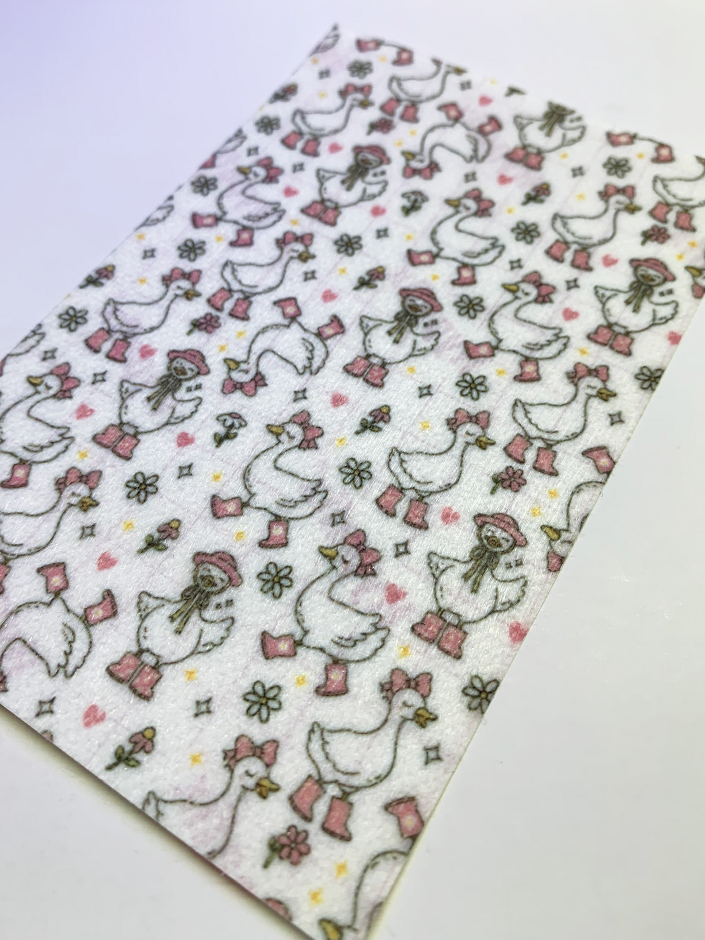 4x6" tubie tape featuring a white background with geese wearing pink boots, bows, and hats in a repeating pattern. Includes flowers, hearts, and small accents in soft pastel tones. Cute, feminine, and playful design.
