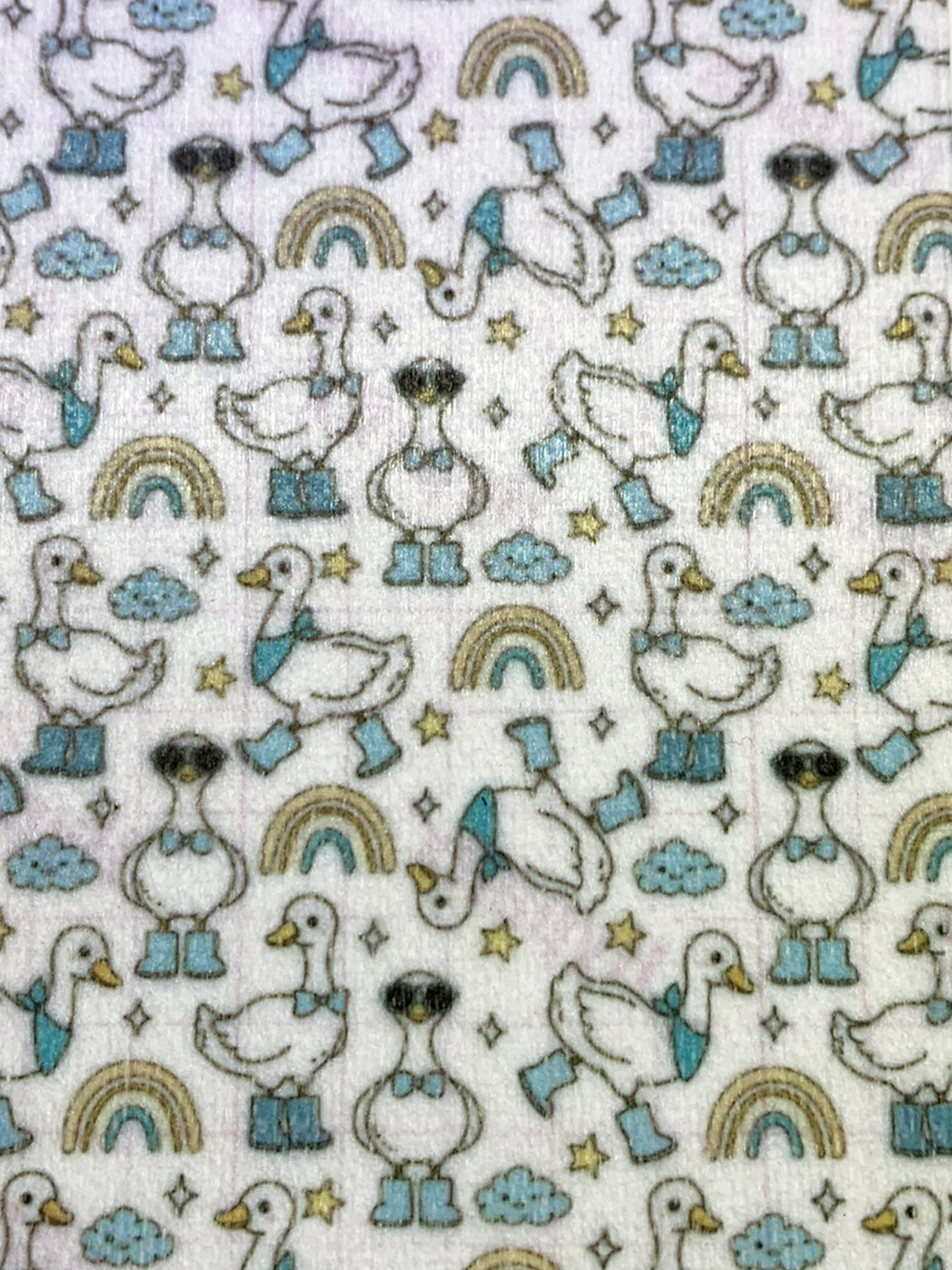 4x6" tubie tape featuring a white background with geese wearing blue boots and bow ties in a repeating pattern. Includes rainbows, clouds, and stars in soft neutral tones. Cute, playful, and whimsical design.
