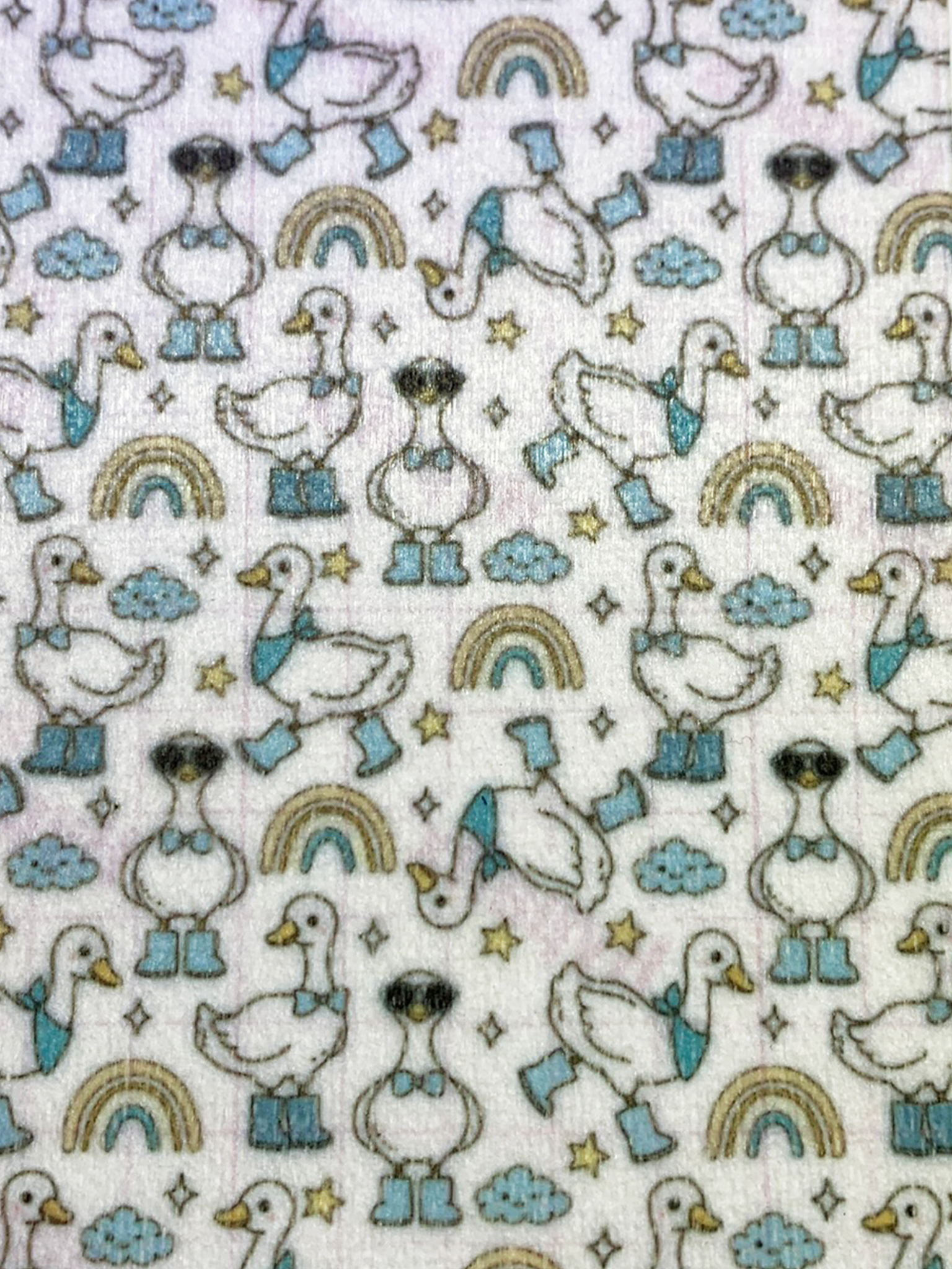 4x6" tubie tape featuring a white background with geese wearing blue boots and bow ties in a repeating pattern. Includes rainbows, clouds, and stars in soft neutral tones. Cute, playful, and whimsical design.
